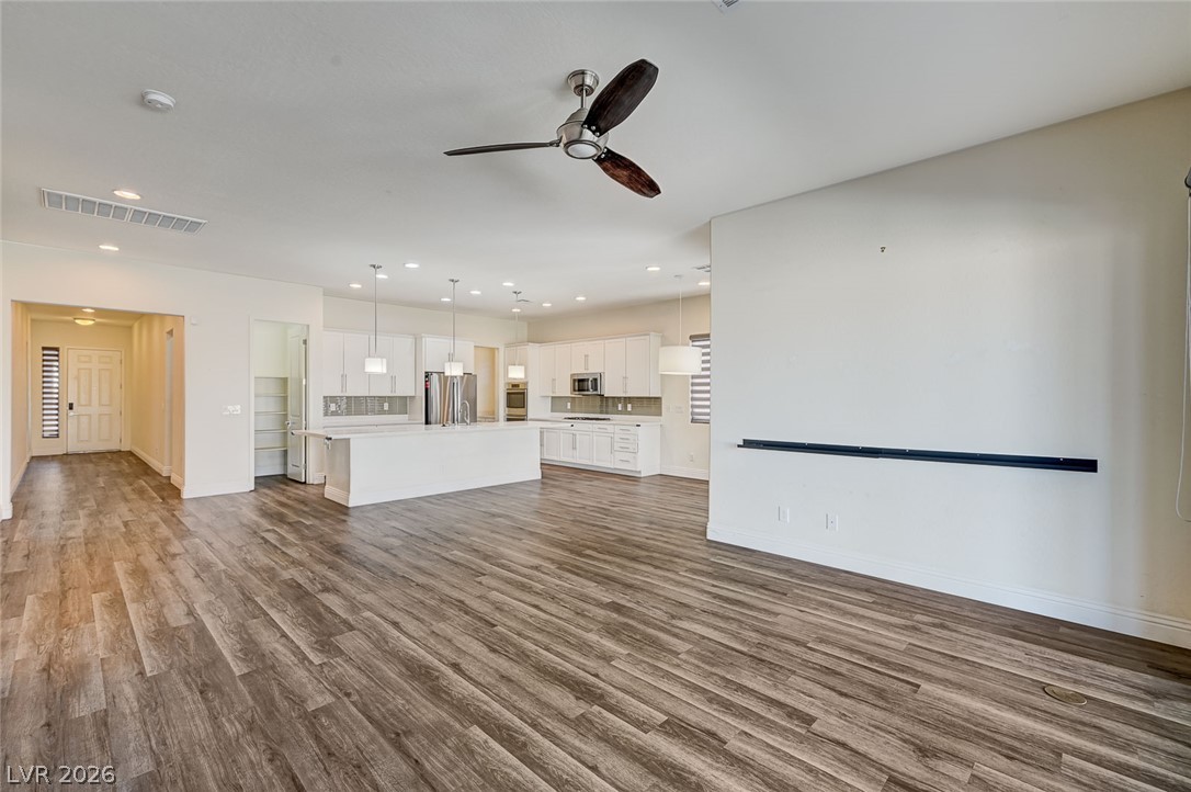 8197 Riley Love Street Las Vegas, NV 89139 - Photo 47 of 48 An open floor plan seamlessly connects the kitchen and living area, perfect for entertaining.