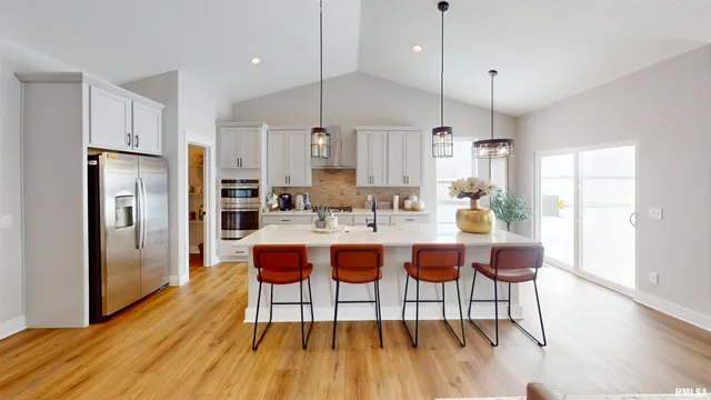 a large kitchen with a table and chairs