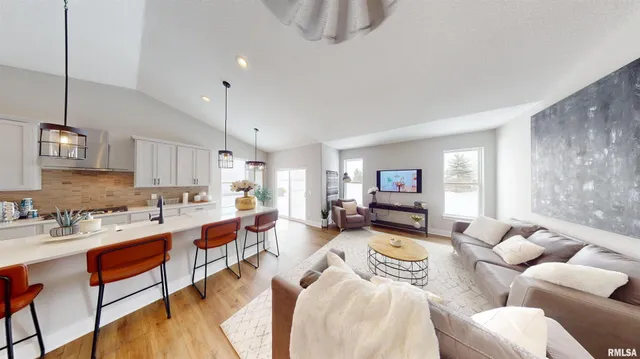 a living room with furniture a rug and a flat screen tv