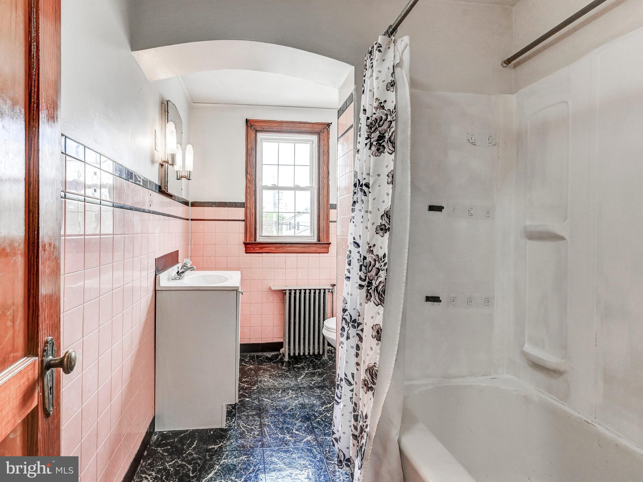 3206 Lynch Road Baltimore, MD 21219 - Photo 27 of 70 a bathroom with a sink a toilet and shower