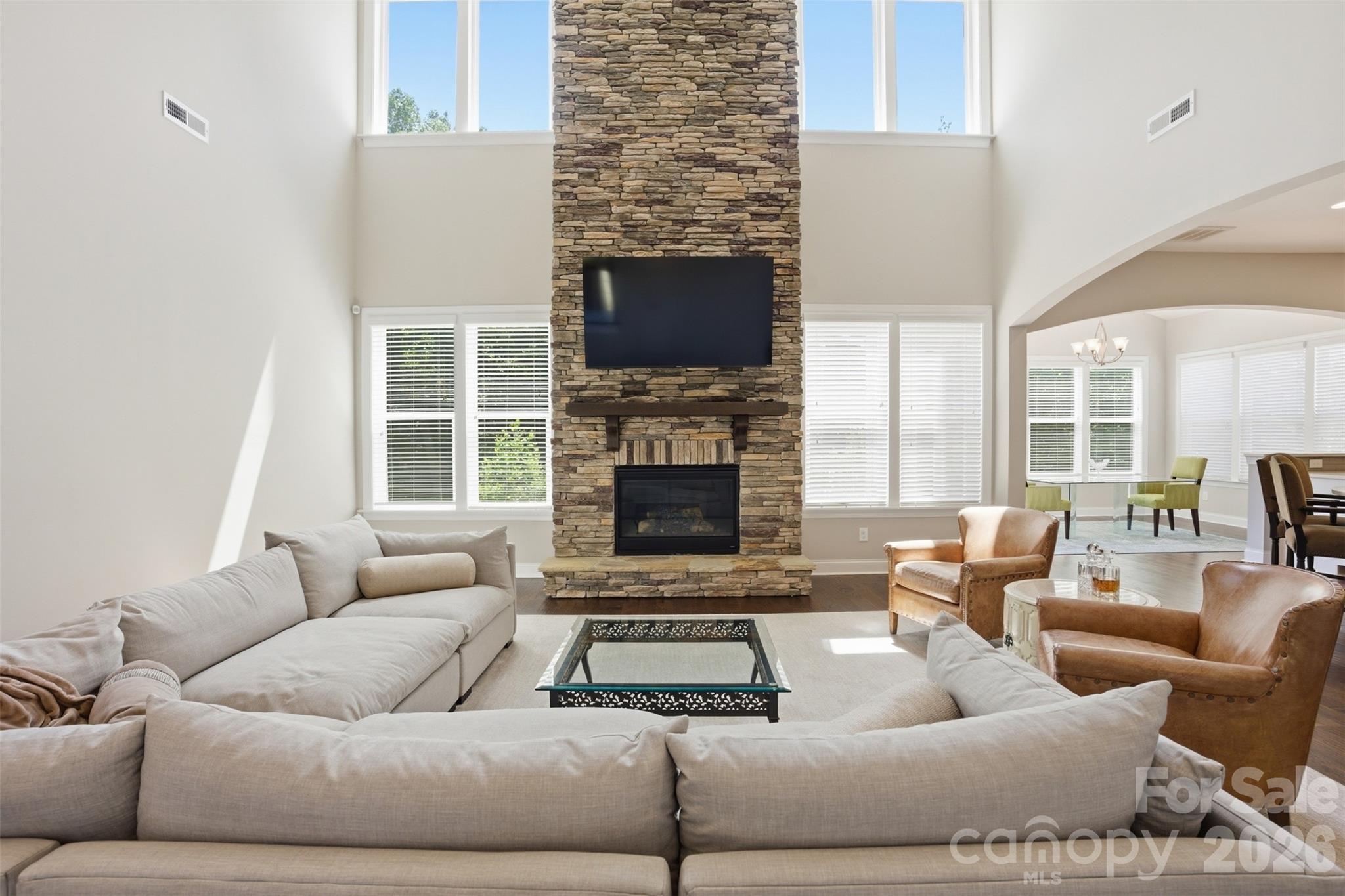 14022 Salem Ridge Road Huntersville, NC 28078 - Photo 10 of 38 a living room with furniture a flat screen tv and a fireplace