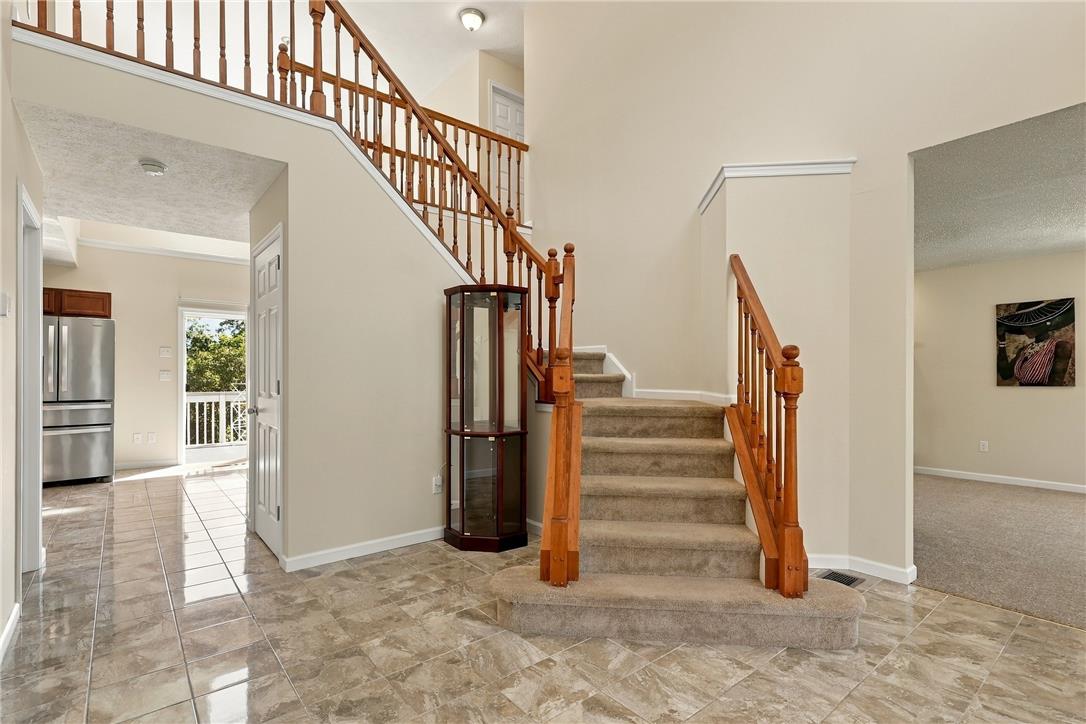 1657 Rachel Road Stroudsburg, PA 18360 - Photo 7 of 46 Polished tile flooring and a classic wooden staircase anchor this airy, multi-level entryway.