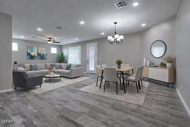 a view of a dining room with furniture and chandelier