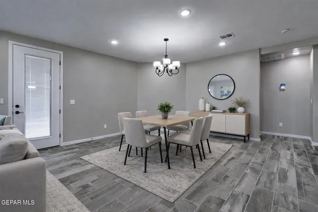 a view of a dining room with furniture and chandelier