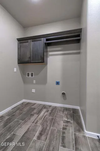 a spacious bedroom with a bed a chandelier and window