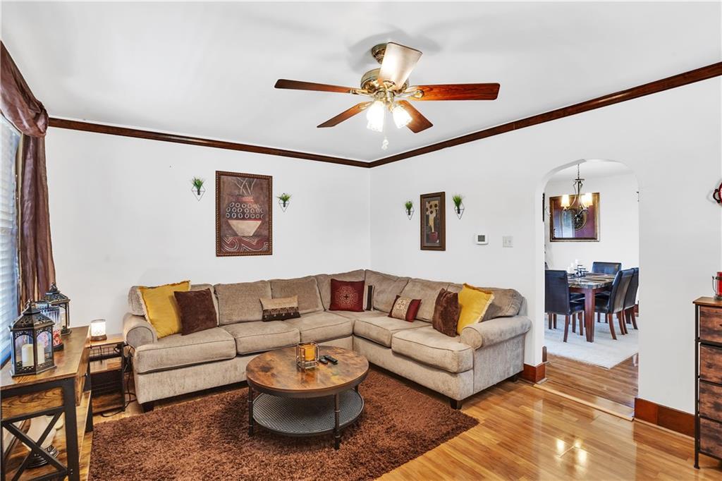 804 George Street Scottdale, PA 15683 - Photo 10 of 34 804 Spacious living room with crown molding, shiny laminate flooring, ceiling fan. Notice the character & charm of the arch way