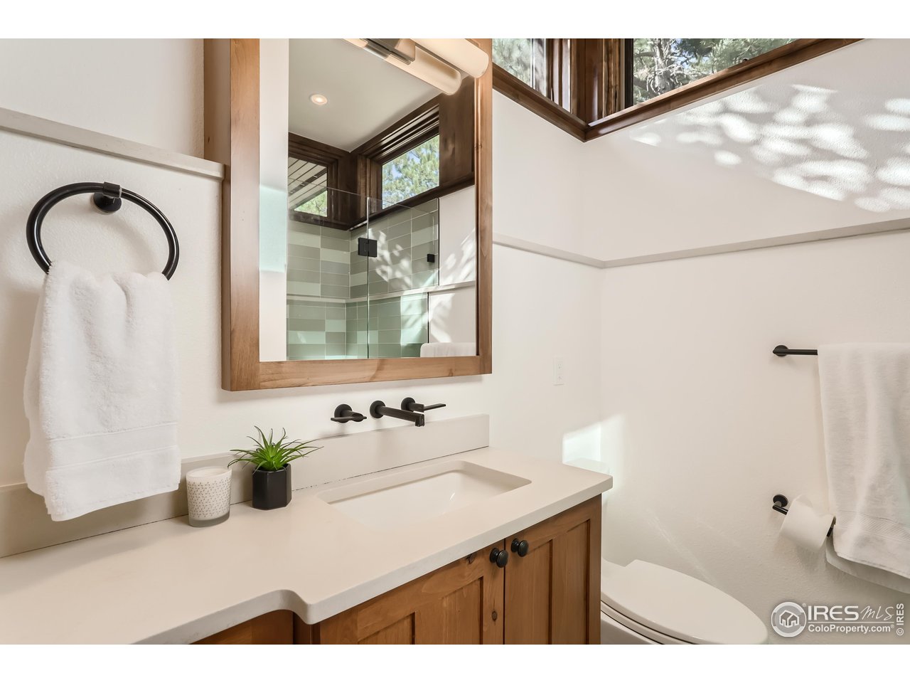 2307 Magnolia Road Nederland, CO 80466 - Photo 17 of 40 a bathroom with a sink a mirror and a shower