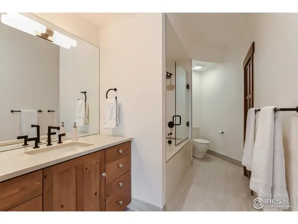 a bedroom with a bed and a night stand