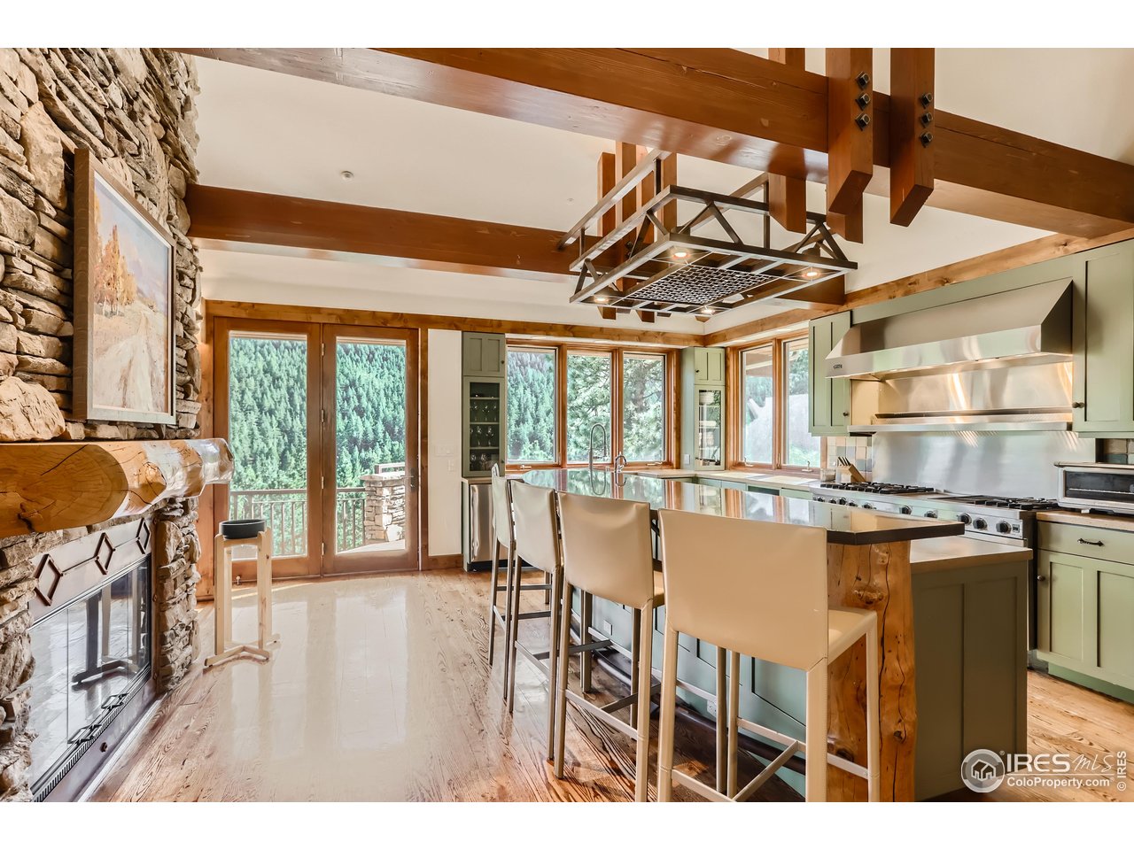 2307 Magnolia Road Nederland, CO 80466 - Photo 4 of 40 a dining room with stainless steel appliances granite countertop a stove and cabinets
