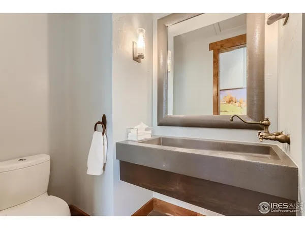 a spacious bedroom with a bed and chair