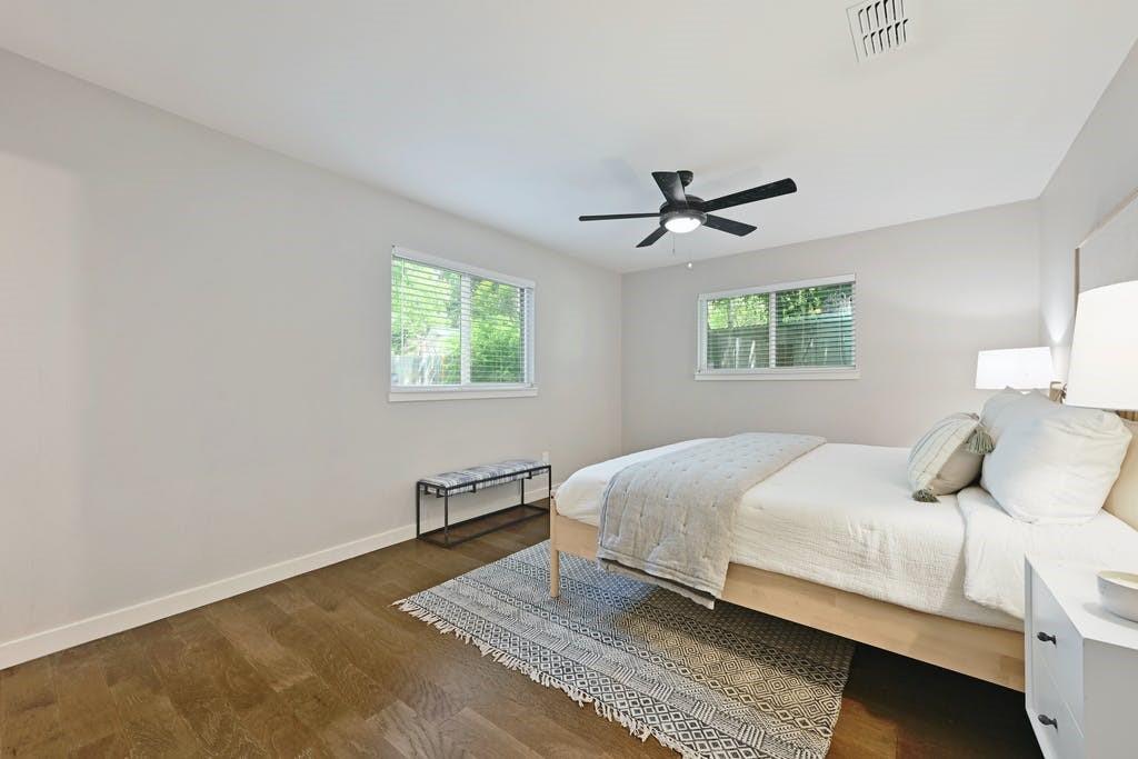 6700 Kings Point Austin, TX 78723 - Photo 21 of 40 Comfortable bedroom with warm wood floors and ample natural light.