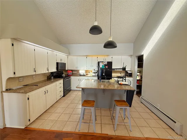 a kitchen with a sink a counter top space cabinets and stainless steel appliances
