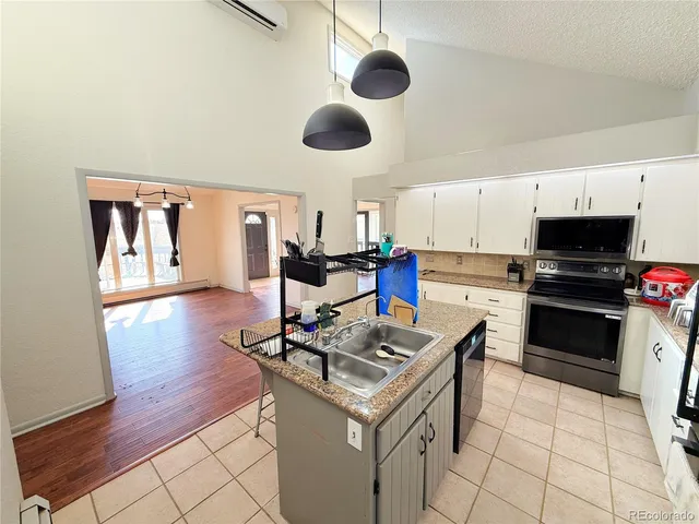 a kitchen with a stove cabinets and wooden floor