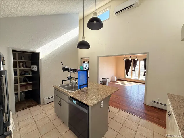 a kitchen with stainless steel appliances granite countertop a sink and a stove