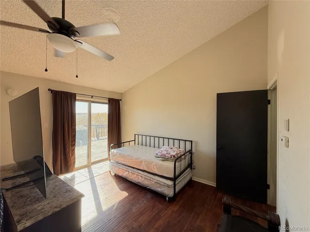 a view of a bedroom with wooden floor and windows