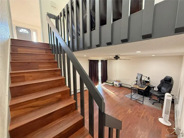 a view of entryway and hall with wooden floor