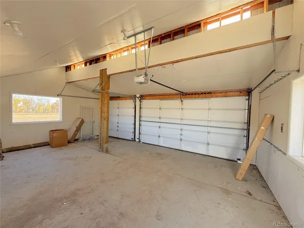 a view of a room with cabinet a ceiling fan and windows