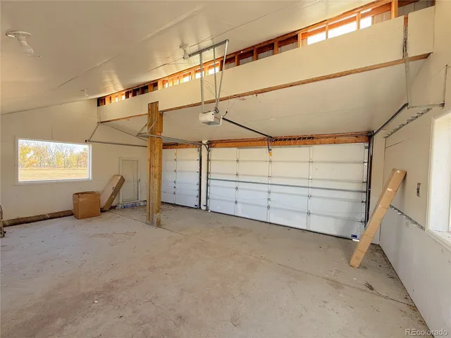 a view of a room with cabinet a ceiling fan and windows