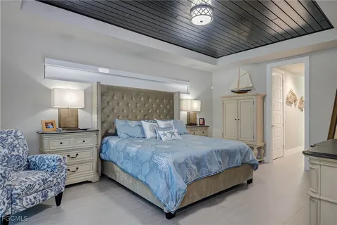 a bedroom with a bed and a dresser with rug