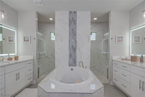 a bathroom with a sink a toilet a shower and a mirror