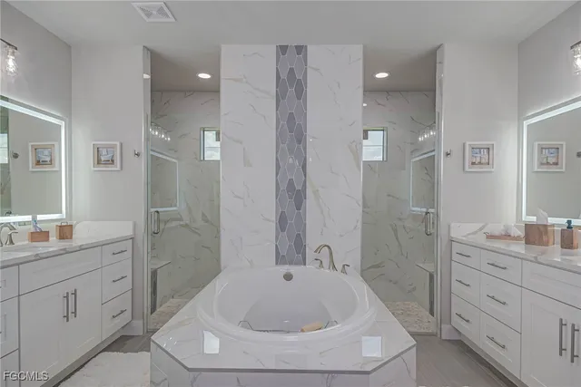 a bathroom with a sink a toilet a shower and a mirror