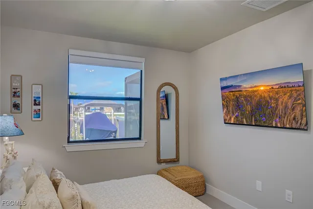 a bedroom with a bed and wall painting