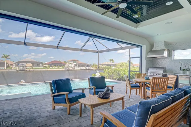 a living room with furniture and a floor to ceiling window