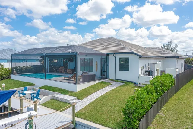 a view of a house with backyard porch and sitting area