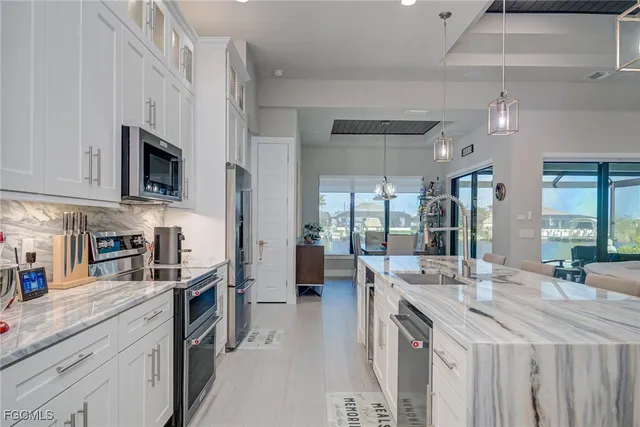 a kitchen with stainless steel appliances granite countertop a lot of counter space and wooden floor