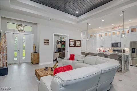 a living room with furniture and kitchen view