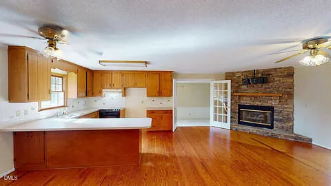 a view of a house with backyard and trees