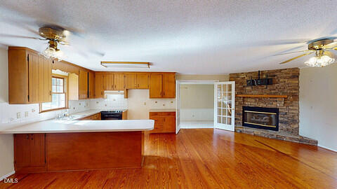 2805 Redwood Road Durham, NC 27704 - Photo 10 of 26 a living room with fireplace furniture and a wooden floor