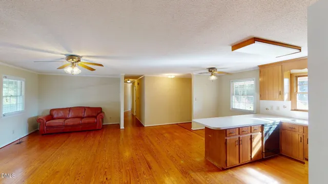 a living room with fireplace furniture and a wooden floor