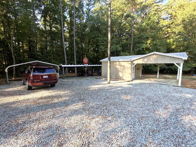 a backyard of a house with yard and outdoor seating
