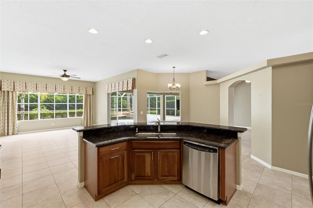 1450 Warrington Way Trinity, FL 34655 - Photo 15 of 62 a kitchen with a sink and a stove top oven