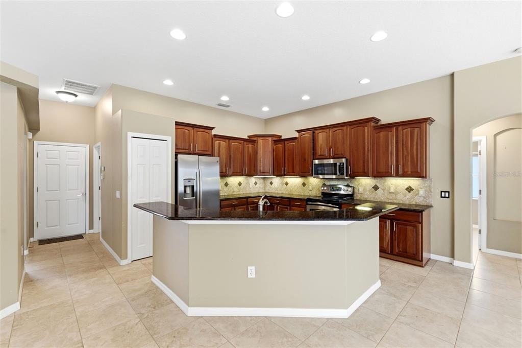 1450 Warrington Way Trinity, FL 34655 - Photo 16 of 62 a kitchen with stainless steel appliances a refrigerator and a stove