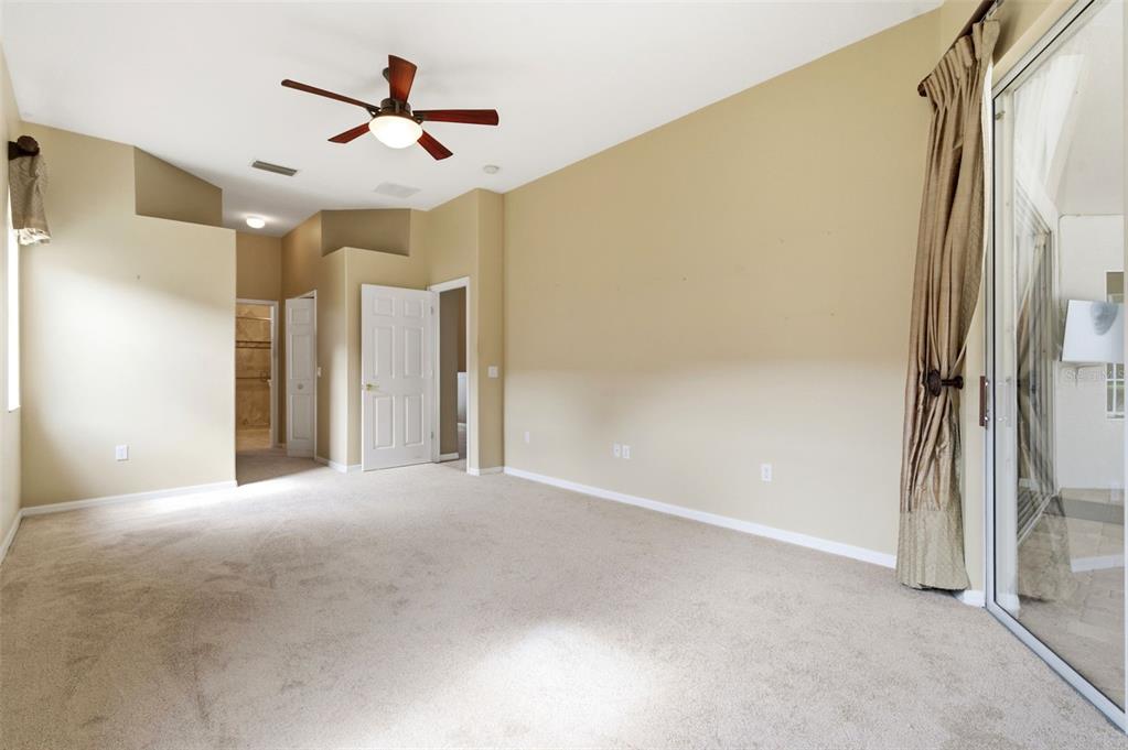 1450 Warrington Way Trinity, FL 34655 - Photo 23 of 62 a view of a livingroom with a ceiling fan & hallway