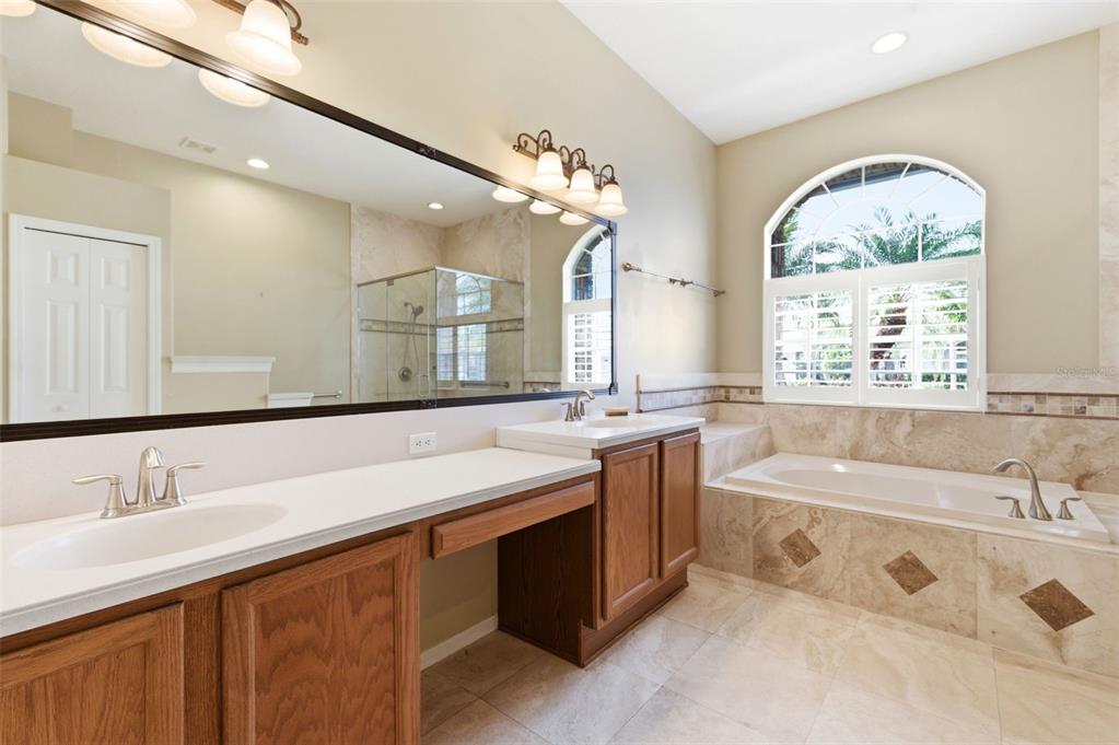 1450 Warrington Way Trinity, FL 34655 - Photo 25 of 62 a spacious bathroom with a tub sink and mirror
