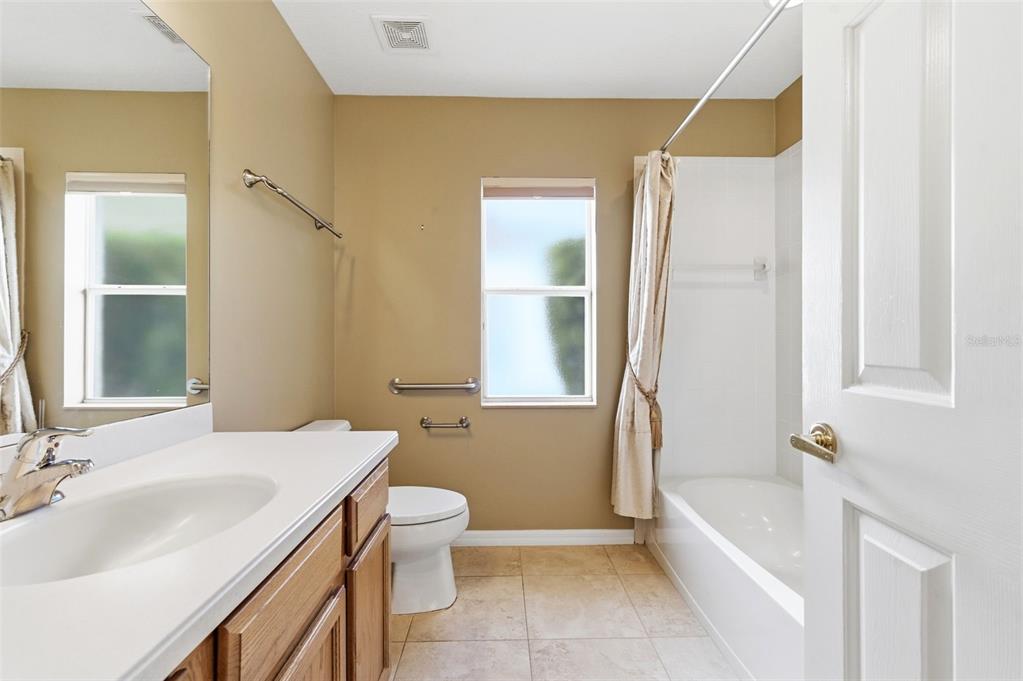 1450 Warrington Way Trinity, FL 34655 - Photo 31 of 62 a bathroom with a sink a toilet and shower