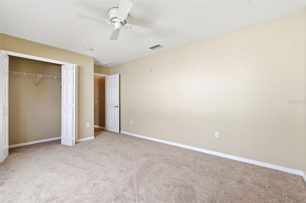 1450 Warrington Way Trinity, FL 34655 - Photo 33 of 62 an empty room with a ceiling fan and a window