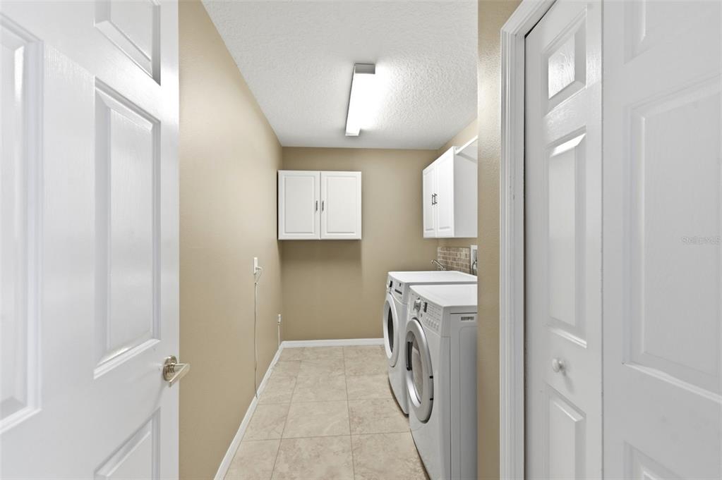 1450 Warrington Way Trinity, FL 34655 - Photo 36 of 62 a utility room with closet dryer and washer