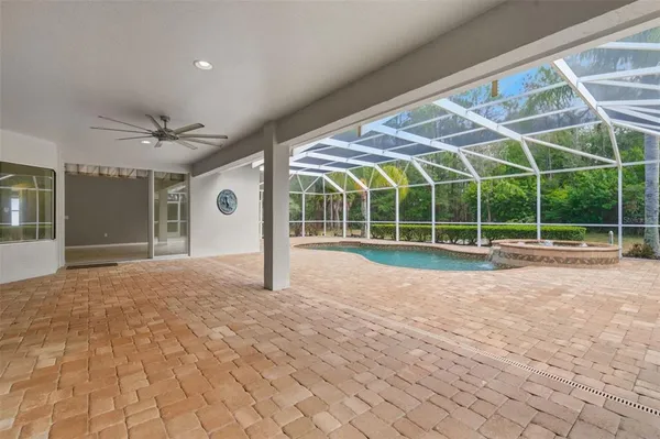 a view of a swimming pool with a bench and trees