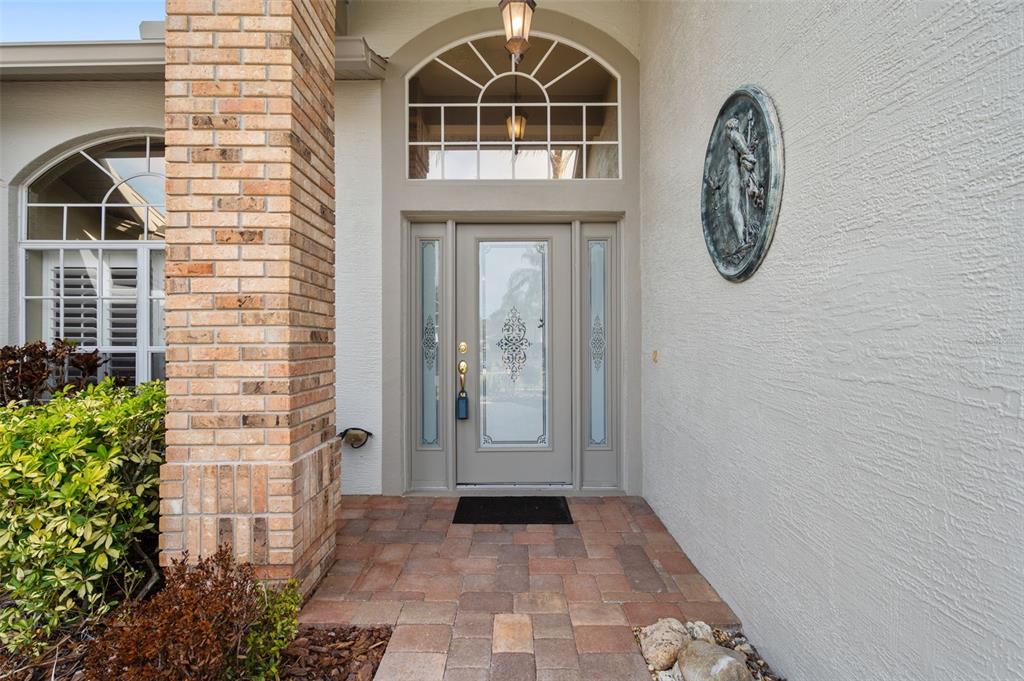 1450 Warrington Way Trinity, FL 34655 - Photo 4 of 62 a front view of a house with a glass door and glass door