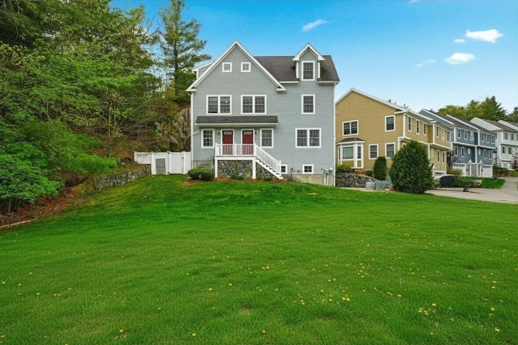 2 B Gates Lane, Unit B Wakefield, MA 01880 - Photo 1 of 42 a front view of a house with a yard and trees