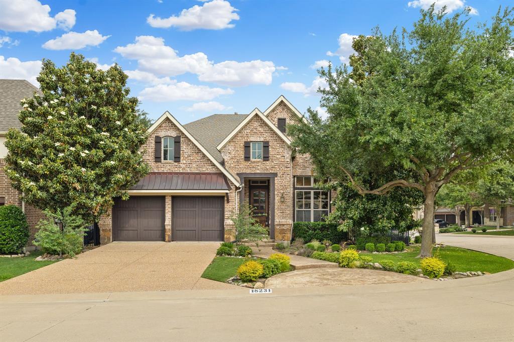18231 Brighton Green Dallas, TX 75252 - Photo 1 of 36 a front view of a house with a garden