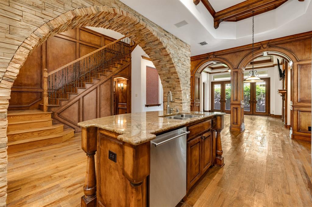 18231 Brighton Green Dallas, TX 75252 - Photo 11 of 36 a kitchen with stainless steel appliances granite countertop a stove and a wooden floors