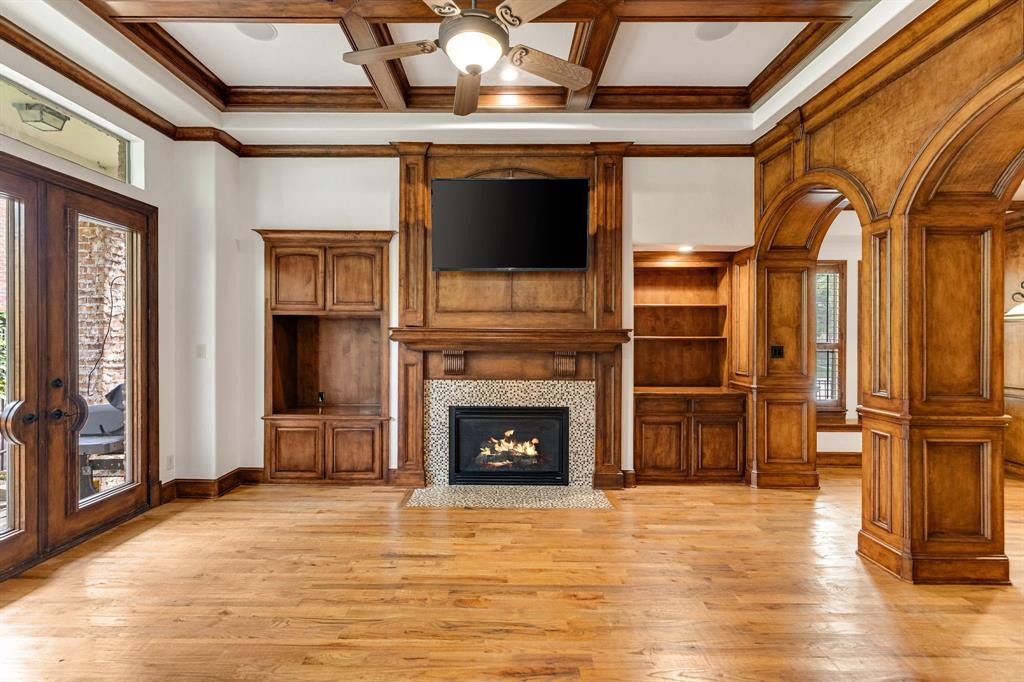 18231 Brighton Green Dallas, TX 75252 - Photo 15 of 36 a living room with a fireplace and a flat screen tv