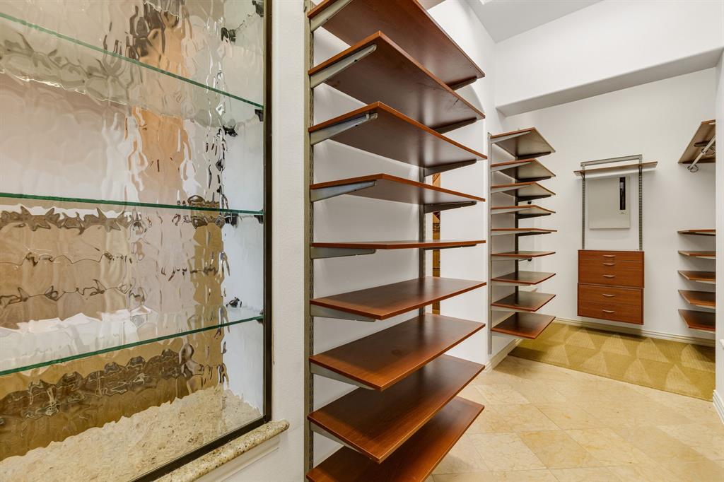 18231 Brighton Green Dallas, TX 75252 - Photo 25 of 36 a view of walk in closet with clothes
