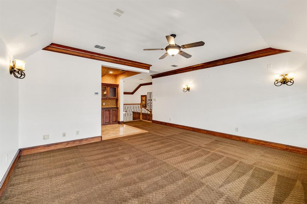 18231 Brighton Green Dallas, TX 75252 - Photo 31 of 36 a view of a room with wooden floor and ceiling fan