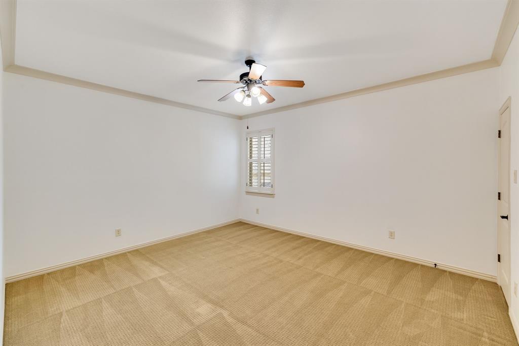 18231 Brighton Green Dallas, TX 75252 - Photo 33 of 36 an empty room with windows and fan